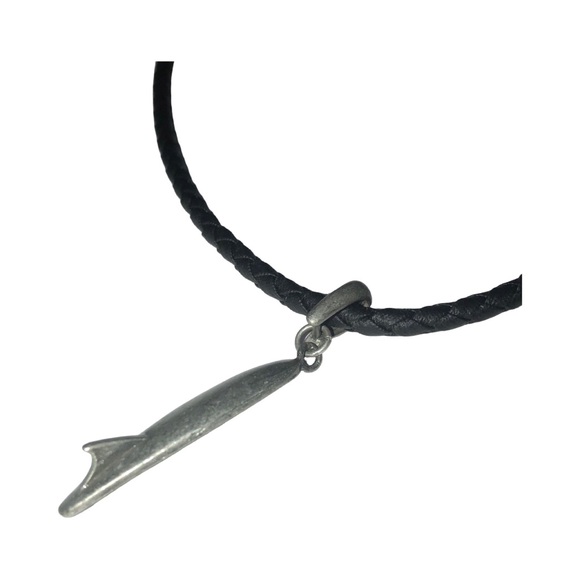 a surfboard-shaped charm or pendant on black cord